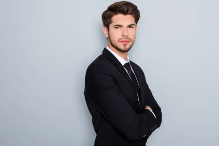 Confident serious successful businessman in suit with crossed  handsの写真素材