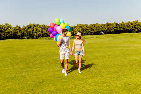 Young happy lovely  family having weekend and walking with balloonsの写真素材