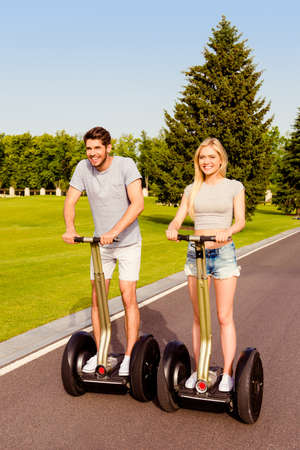 Portrait of young happy family having holidays and riding segwaysの写真素材