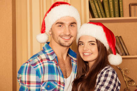 Happy toothy young friends in santa hatsの写真素材