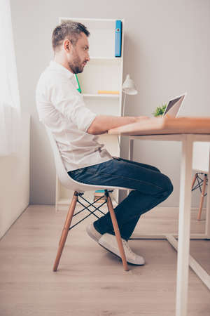 Serious businessman in glasses working in office with laptopの写真素材