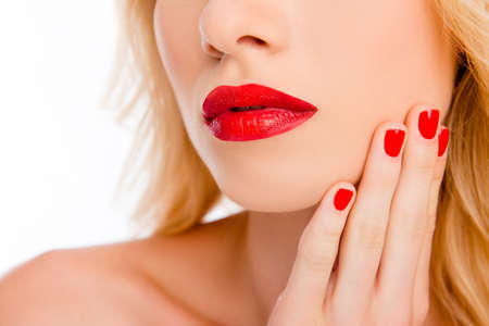Close up of big woman's red lips and hand with red manicureの写真素材
