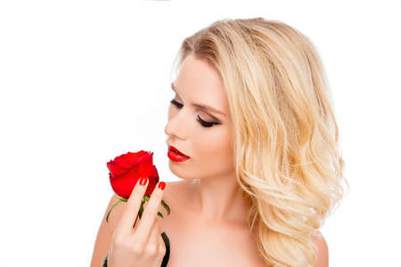 Young beautiful girl with perfect skin holding red roseの写真素材