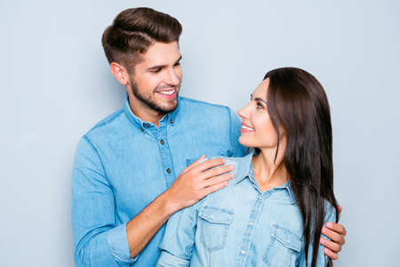 Happy cheerful man and woman looking at each other with love