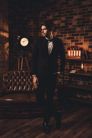 Young sexy handsome  man dressed in elegant black suitの写真素材