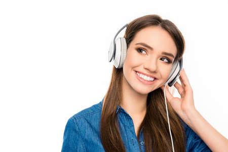 Portrait of happy music lover listening music in headphonesの写真素材