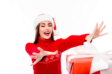 Happy santa woman trying to catch xmas presentsの写真素材
