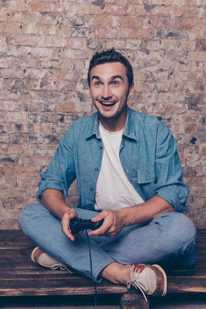 Happy excited handsome man playing video game