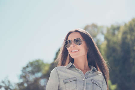 Portrait of cheerful beautiful woman in spectacles on the background of sky