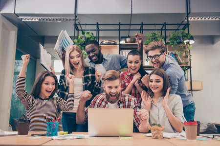 Yes! Happy multinational young managers successfuly completed hard projectの写真素材