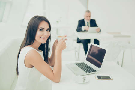 Portrait of happy cheerful secretary having break and drinking coffee