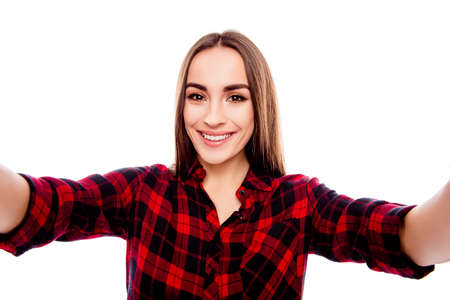 Pretty happy woman with beaming smile making selfie