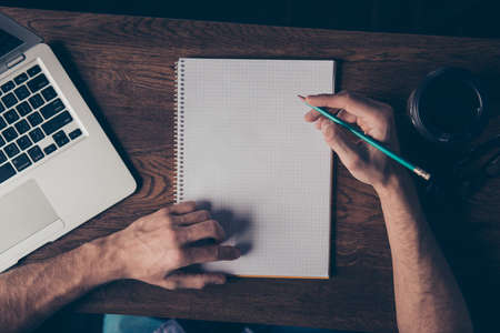 Close up of young man drawing scheme in his notebookの写真素材