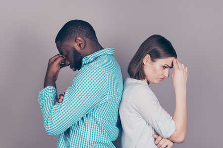 two mixed race people having headaches and stress.