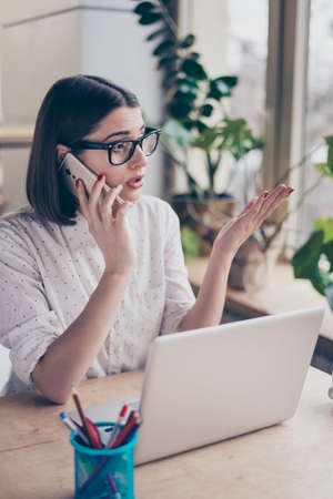 Happy pretty businesswoman talking on mobile phoneの写真素材