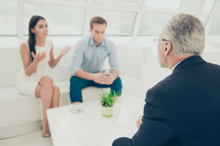 Portrait of young family with problems at a reception of psychologistの写真素材