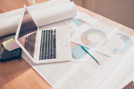 Photo of working place of engineer with blueprint, diagramas and laptopの写真素材