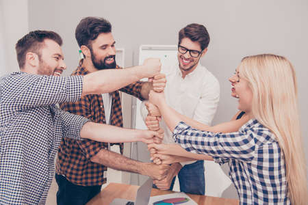 Happy businesspeople putting their fist on top of each otherの写真素材