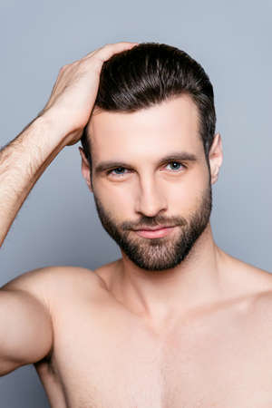 Handsome smiling young man doing modern hairstyleの写真素材