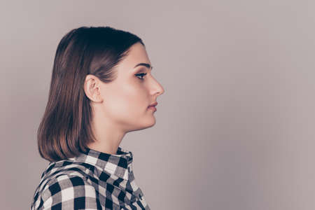 Side view photo of young cheerful woman  on gray backgroundの写真素材