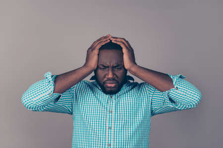 Portrait of sad afroamerican  bearded  man holding head.の写真素材