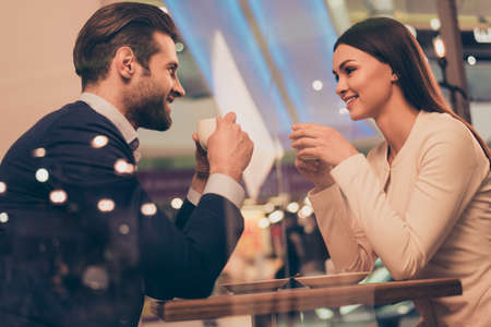 Lovely romantic couple sitting in a cafe with coffee