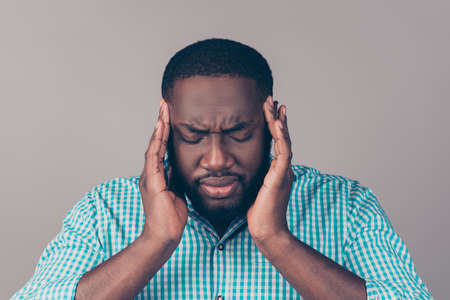 Portrait of bearded   afroamerican man touch head. He have strong migraine