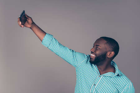 Portrait of happy afroamerican  bearded  man makes selfie photo and smilingの写真素材