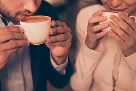 Lovely romantic couple sitting in a cafe drinking coffeeの写真素材