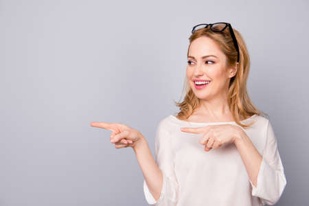Attractive happy business woman pointing awayの写真素材