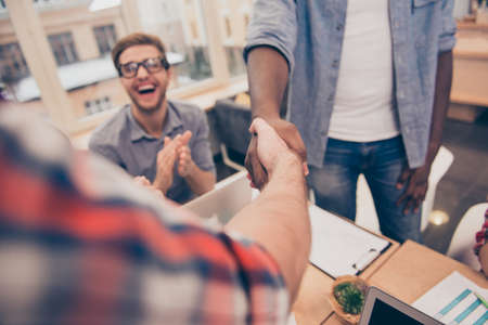 Close up of business people shaking hands successfuly  finishing up a meetingの写真素材