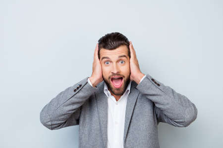 Young handsome man covering his ears with hands for not to hear rumorsの写真素材