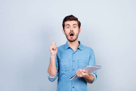 Eureka! Young smart man invented brand new idea for business. He is shockedの写真素材