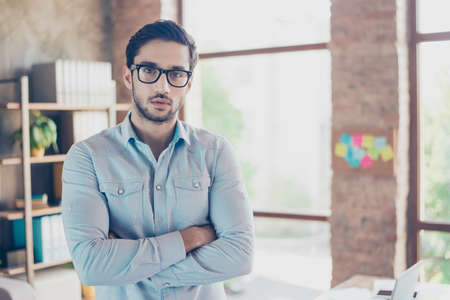 Successful young handsome middle eastern man lawyer in a formal outfit and glasses with crossed hands. Severe and harsh, rich and confident, attractive and smartの写真素材
