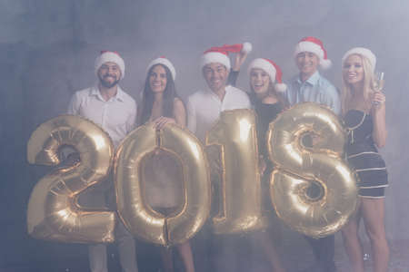 Funky, fooling, laugh, relaxation. Chilling group of six students in dresses, shirts, xmas headwear, amazed, cheerful at the nightlife clubbing as a tradition of celebrationの写真素材