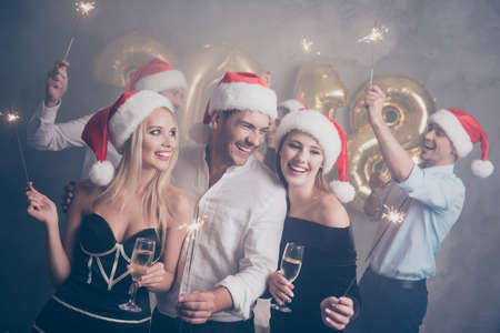 2018! Dancing bonding beautiful cute amazed festive crowd of youth, with fires on luxury feast, in classy outfits, so glamorous and fancy! Relax disco mood, celebrating newyear all night long!の写真素材