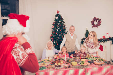 Santa came and brought presents gifts surprises! Cheerful relatives bonding near setted festive...