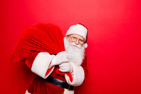 Holly jolly x mas festive noel miracles and magic time! Funny santa in headwear, costume, black belt, white gloves brings a lot of gifts for kids, ready, prepared, sale promotion conceptの写真素材