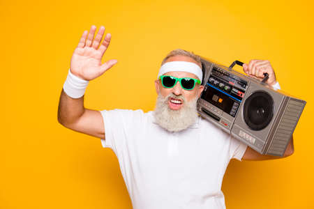 Cheerful excited aged funny sexy gangster cool grandpa dude in eyewear with bass clipping ghetto...