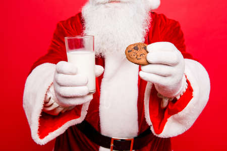 Close up cropped of relaxed serene santa in costume, white gloves going to have a pause with tasty treats, beverage, dream, december time. Holly jolly x mas festive noel!の写真素材