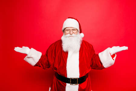 Santa is gesturing with hands like he is holding something and need to choose between two optionsの写真素材