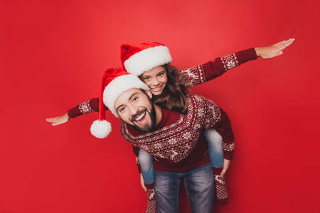 Adorable sweet guy dad with small cute girl fooling around, excited in knitted cute traditional x mas costumes with ornament, head wear, socks, jeans, december, noel time, freedom, celebrate, winterの写真素材