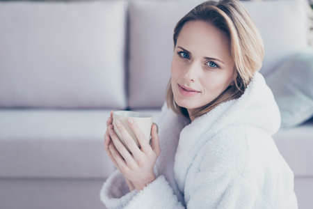Close up portrait of charming beautiful nice looking young woman with blonde short hair, she is...