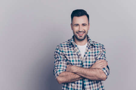 Portrait with copy space of young attractive, stunning, smiling man having his hands crossed, looking at cameraの写真素材