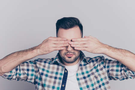 Close up portrait of tired man with stubble after long working day on computer having eye problem, pressureの写真素材