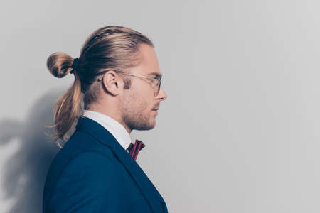 Half face close up portrait  bearded man in glasses with tail in formal outfit over grey backgroundの写真素材
