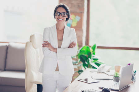 Nice, charming, pretty, attractive woman in glasses, formalwear, white suit with crossed arms...
