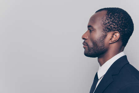 Side profile view portrait of smart experienced qualified clever strict head on big company clothed in black jacket and white shirt looking aside isolated on gray background copyspace