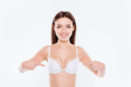 Portrait of beautiful perfect sexual slim lovely cute cheerful girl with good proportions demonstrating her sexy big tits isolated on white background, wellbeing, wellness conceptの写真素材