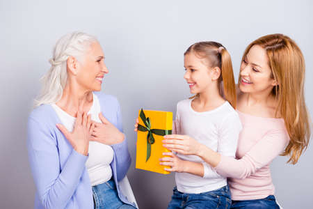 International women's day concept. Cute tender lovely cheerful mum and small preteen giving yellow...